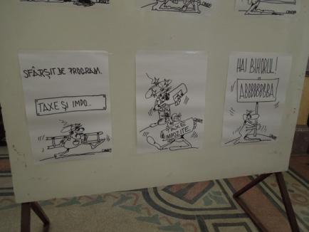 Taxele şi impozitele plătite de orădeni, caricaturizate într-o expoziţie la Primărie (FOTO)