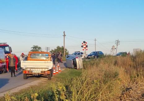 Accident la intrarea în Livada de Bihor: Beat criţă, un şofer s-a răsturnat lângă trecerea peste calea ferată (FOTO/VIDEO)