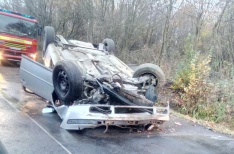 Accident la Sărand: O maşină s-a răsturnat după ce a derapat pe criblura de pe şosea (FOTO)