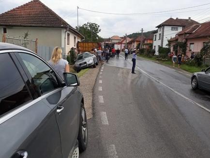 Curbă periculoasă! Un TIR s-a răstunat în centrul comunei Răbăgani acroşând un Audi A4 (FOTO)
