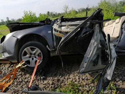 O maşină s-a izbit de tren lângă Finiş şi a fost târâtă 100 de metri. Un bărbat, în stop cardio-respirator (FOTO / VIDEO)