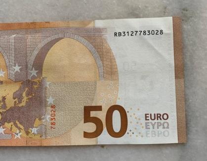 Cum au ajuns bancnote false de 50 de euro pe piaţa din Oradea şi Marghita. DIICOT a făcut percheziţii în dosar