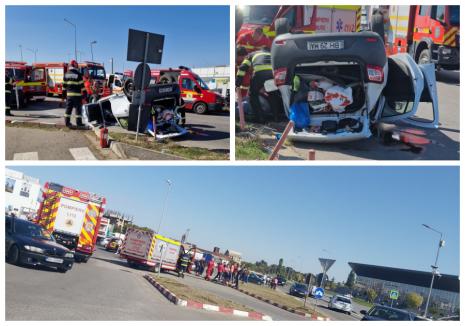 Accident în Oradea, în zona Auchan: O mașină a ajuns cu roțile în sus. O femeie a fost dusă la spital (FOTO)