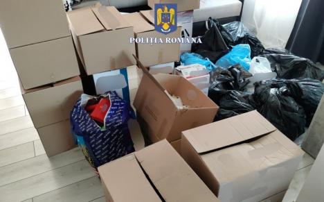 Percheziţii în Oradea şi Sântandrei: Peste 3.000 de poşete şi accesorii pentru telefoane mobile contrafăcute au fost confiscate de la doi tineri (FOTO)